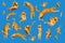 Many ginger flying and jumping funny cats isolated on a blue background