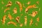 Many ginger flying and jumping funny cats isolated on a green background
