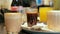 Many glasses with coffee and juice are placed on the counter in a cafe