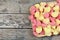 Many gnocchi hearts on a wooden cutting board