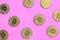 Many golden bitcoins lies on a blanket made of soft and fluffy light pink fleece fabric. Physical visualization of virtual crypto