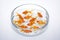 Many goldfish in a glass fishbowl on white background