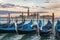 Many gondolas in Venice in Italy at sunset