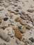 Many gravel rocks lined the sand on the beach