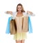 So many great deals. Studio shot of an ecstatic woman looking into shopping bags she is holding.