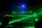 Many green lasers bounce off walls along the way