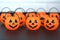 Many halloween pumpkins with scary faces looking forward