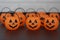 Many halloween pumpkins with scary faces looking forward