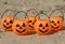 Many halloween pumpkins with scary faces looking forward