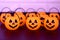 Many halloween pumpkins with scary faces looking forward