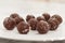 Many handmade chocolate truffles on a white plate