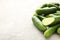 Many harvest cucumbers on the grey concrete background with copy