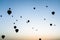 many hot air ballons in sky at sunrise