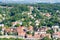 Many houses on a hill among trees. Dense population in the city. A photo taken from a bird`s eye view