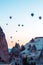Many huge balloons are flying in the air at the sunrise. Cappadocia, Turkey.