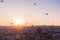 Many huge balloons are flying in the air at the sunrise. Cappadocia, Turkey.