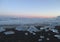 Many icebergs on the black sand beach under the beautiful sunset sky