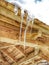 Many icicles melt on the wooden roof with water drops. Spring is comming.