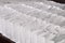 Many identical white cardboard paper gift bags