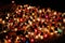 Many illuminated, colorful candles stand side by side