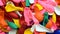 Many inflatable balloons of colors, deflated in a pile, colorful background 3