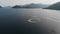 Many jet skis ride in a circle in the sea on the background of beautiful Islands in azure water. Aerial shot 4K