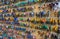 Many keys with colorful plastic key tags hanging on hooks on the wooden board.