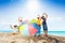 Many kids standing with sun umbrella on beach