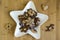 Many kinds of Christmas cookies on white plate, gingerbread dark and light, star shape dish