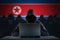 Many Korean hackers in troll farm. Security and cyber crime concept. Korea flag in background.