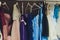 Many ladies evening gown long dresses on hanger in the dress rent shop for the wedding day. Dresses rental concept