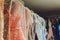 Many ladies evening gown long dresses on hanger in the dress rent shop for the wedding day. Dresses rental concept
