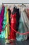 Many ladies evening gown long dresses on hanger in the dress rent shop for the wedding day or photo session. Dresses