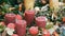 Many large multi-colored Christmas thick wax candles standing in holly and spruce. The spirit of Christmas and the new