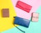 Many leather purses on a colored pastel background. Top View.
