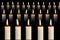 Many lit candles in rows on black background. Faith, religion, honor or spirituality concept.