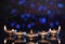 Many lit diyas on dark background with blurred lights, space for text. Diwali lamps