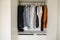 Many man`s clothes in wardrobe, closeup. White wardrobe