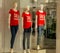 Many mannequins wear a red shirt with the word