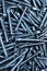 Many metal furniture screws - blue tinted background