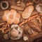 Many mixed baked breads and rolls on rustic wooden table