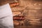 Many mixed baked breads and rolls on rustic wooden table