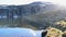 Many mosquitoes flying over the mountain lake near snow road Aurlandsvegen. Norway.