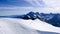 Many mountain climbers moving like ants across a large glacier in the French Alps near CHamonix