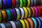 Many multi-colored spools coils of thread of filament for printing 3d printer.