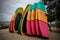 Many multi-colored surfboards in a row for rent