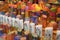 Many multicolored colorful red orange yellow paraffin stick candles arranged on shelves