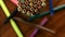 Many multicolored pencils move in a circle on a black wooden background with markers. Concept office or school, knowledge day, the