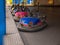 Many multicolored retro bumper cars waiting for people in a luna park