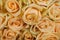 Many natural beige roses background, close up